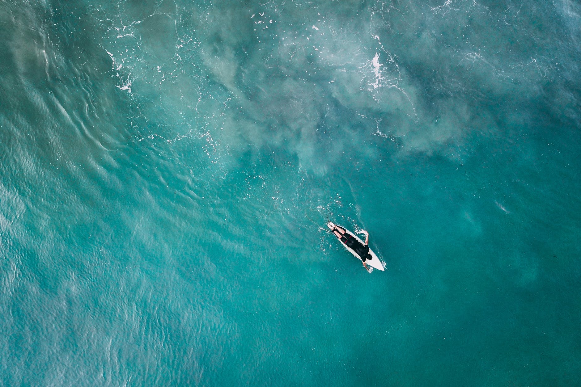 surfer on board in vivid blue reservoir