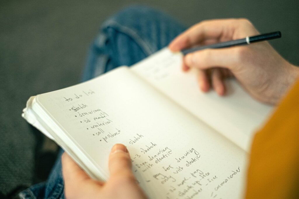 person writing a to do list