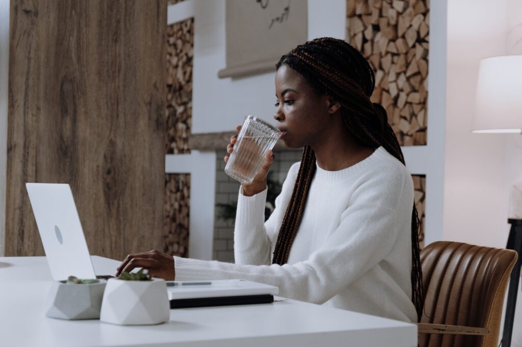 woman in white long sleeve shirt sitting at the table